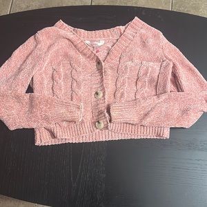 a matching sweater and top in pink.